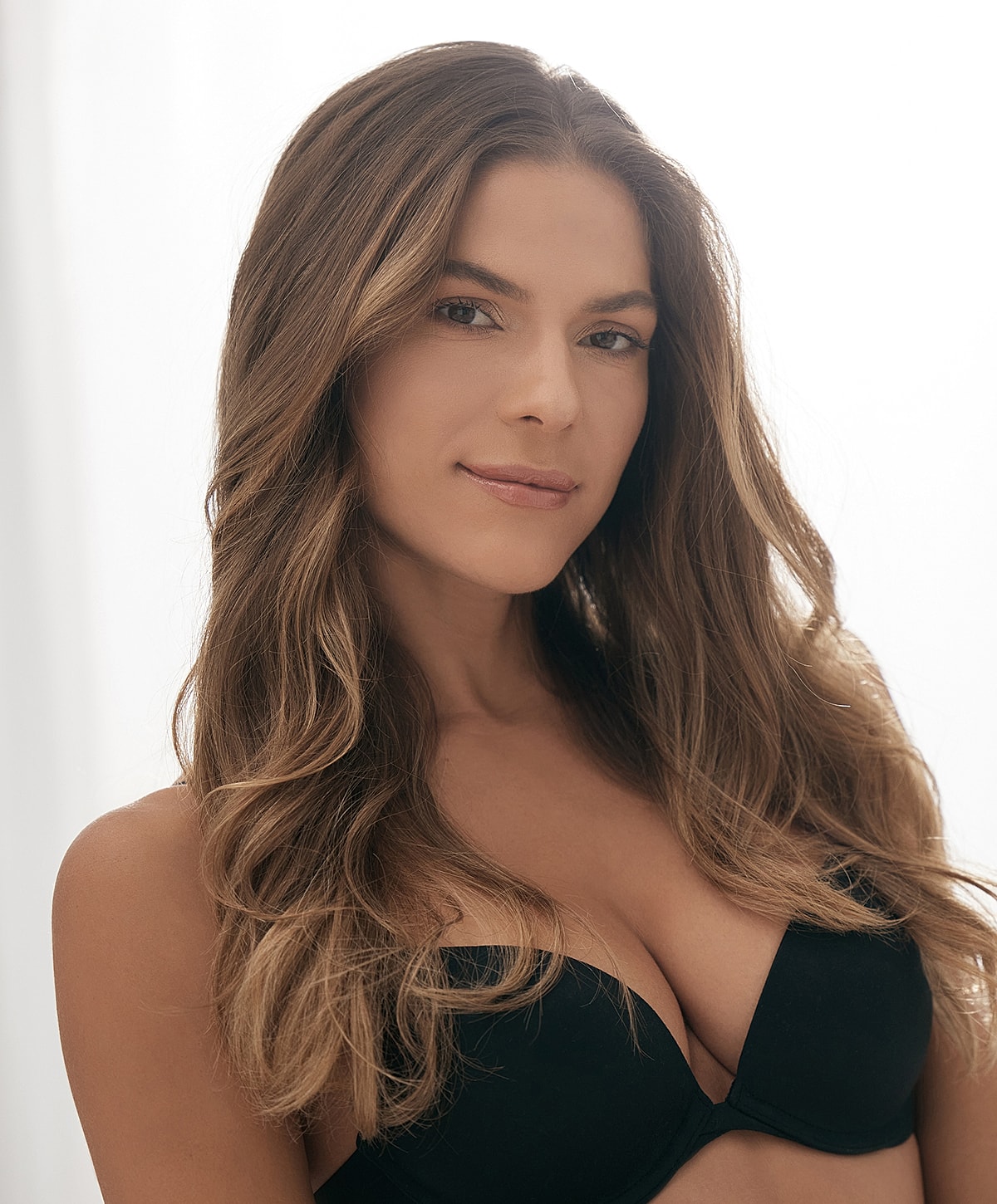 Woman with long hair and black bra.