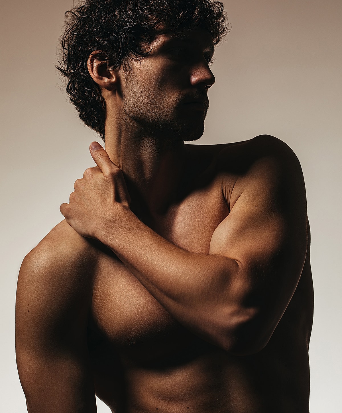 Man in silhouette with muscular build and pose.