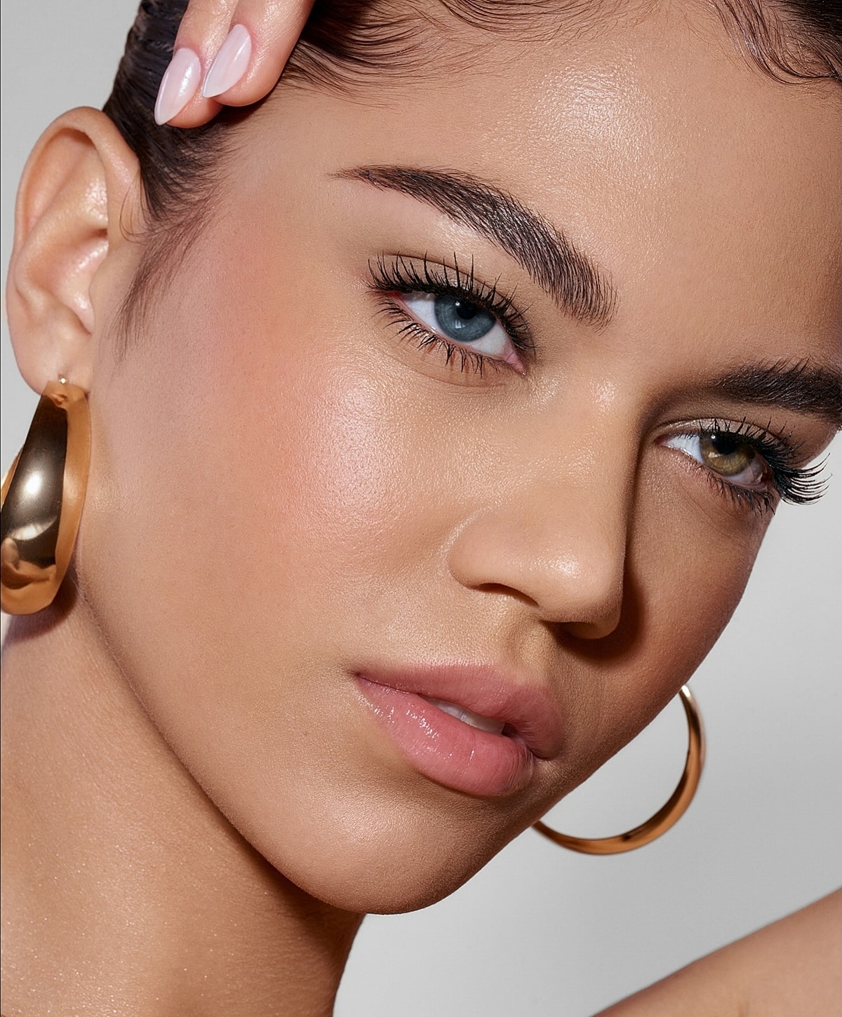 Close-up of a woman's face with striking eyes.