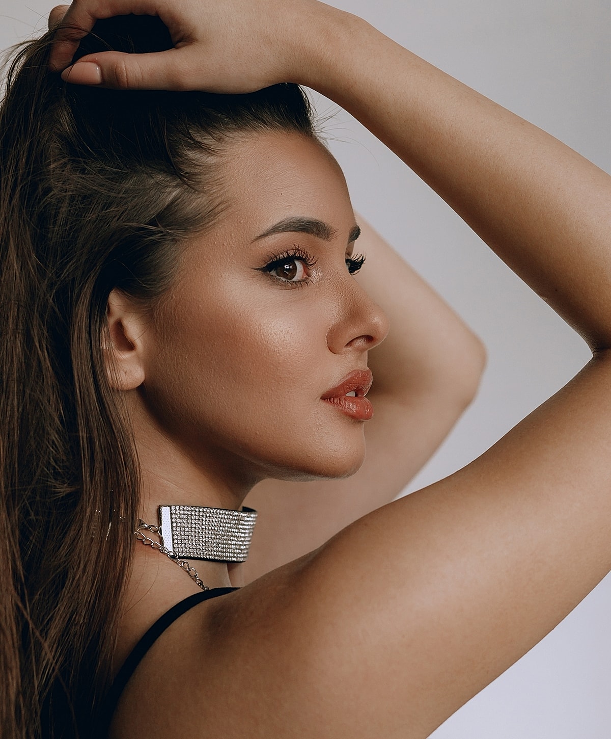 Profile of a woman with stylish jewelry.