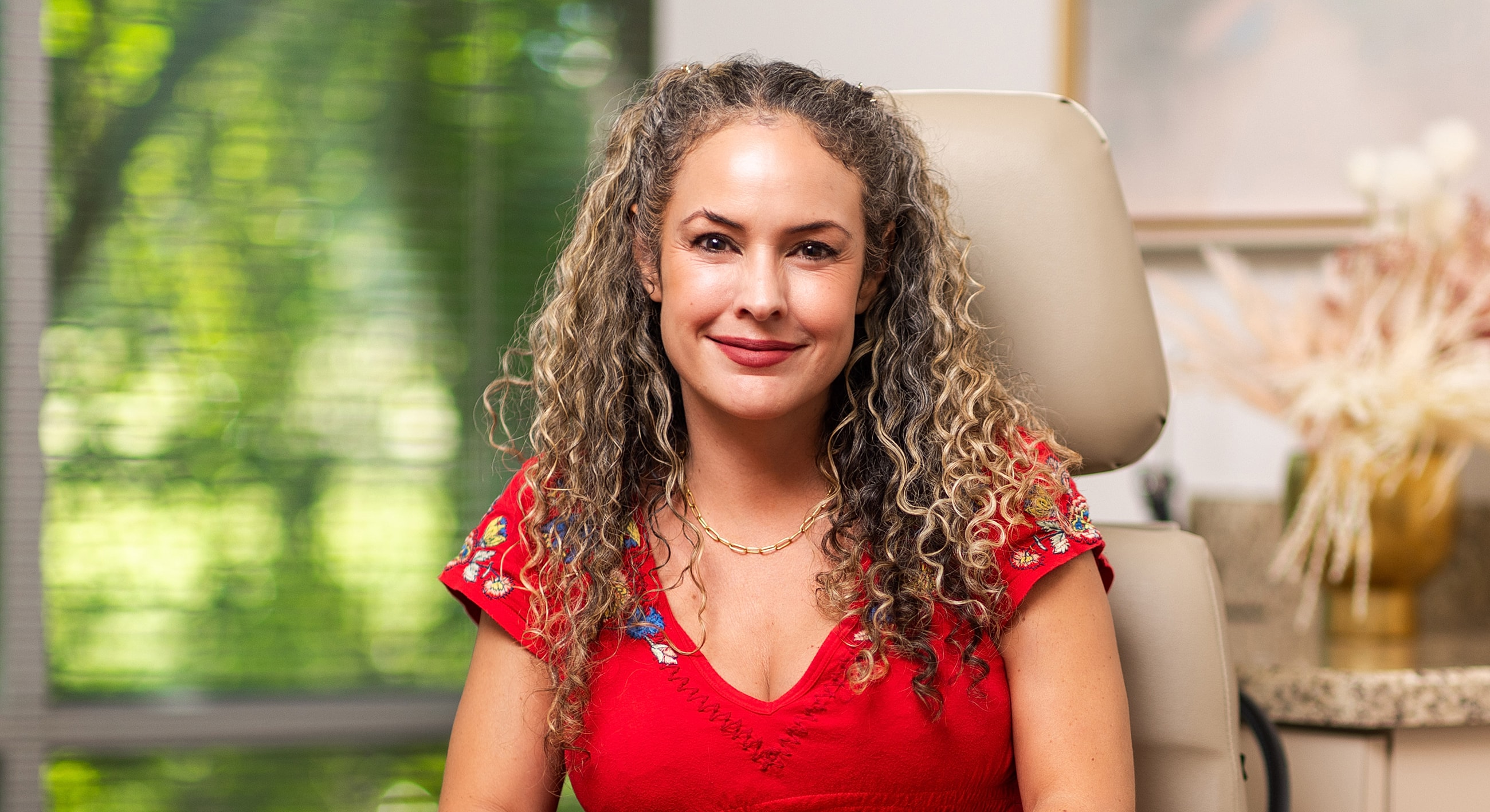 Woman smiling in professional office setting.