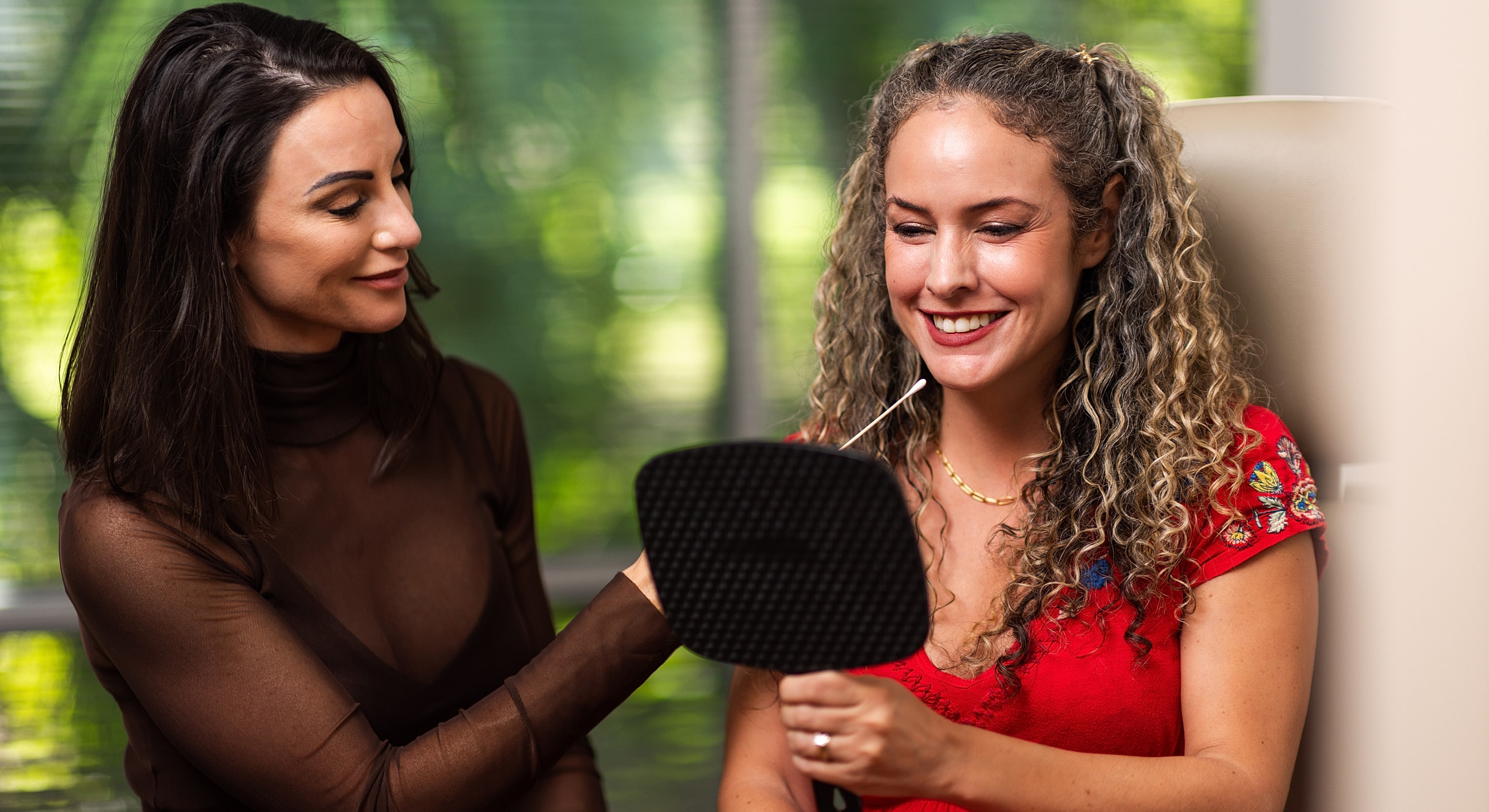 Two women sharing a beauty experience together.