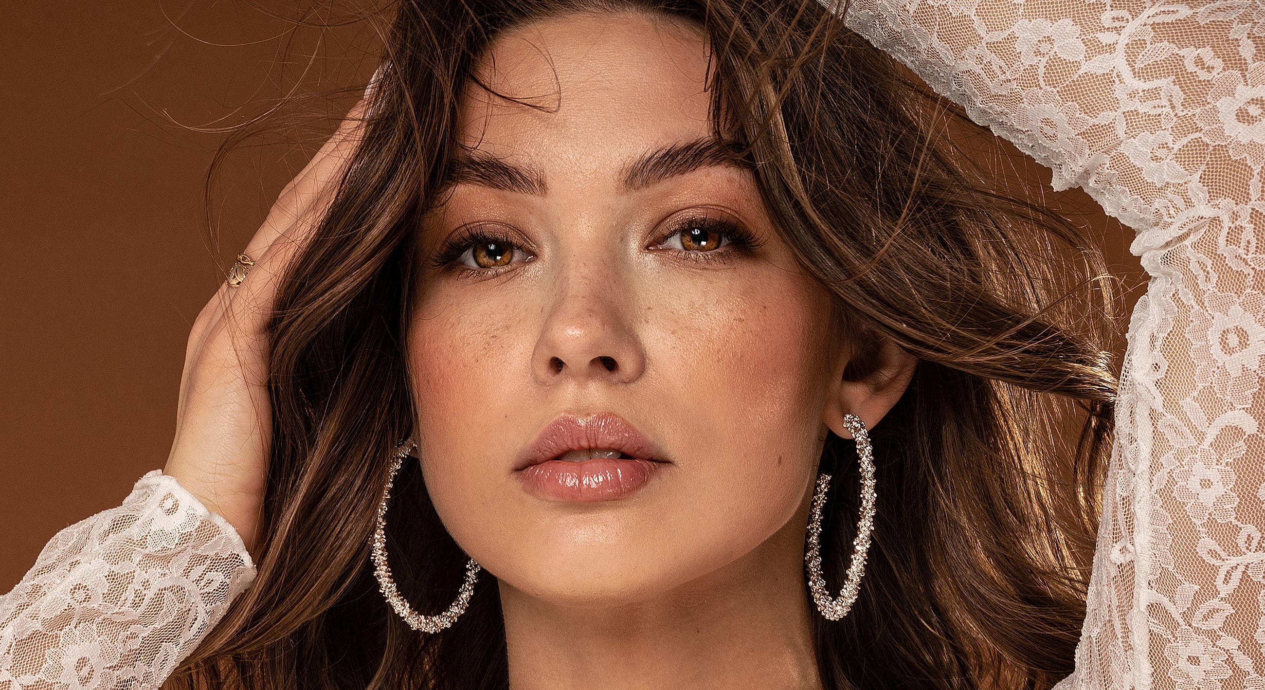 Close-up of a woman with elegant earrings.