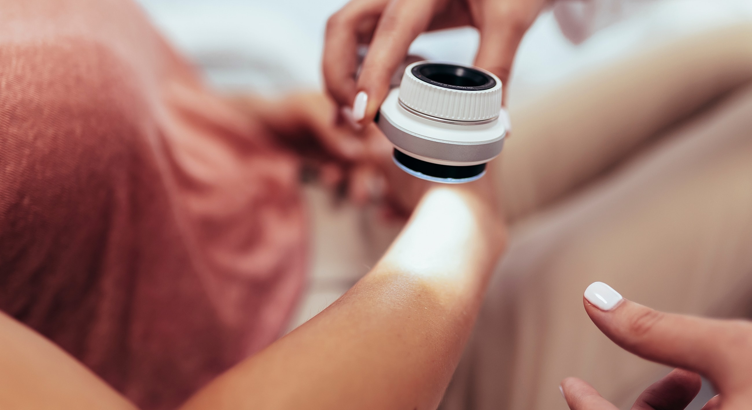 Skin examination with dermatological tool.
