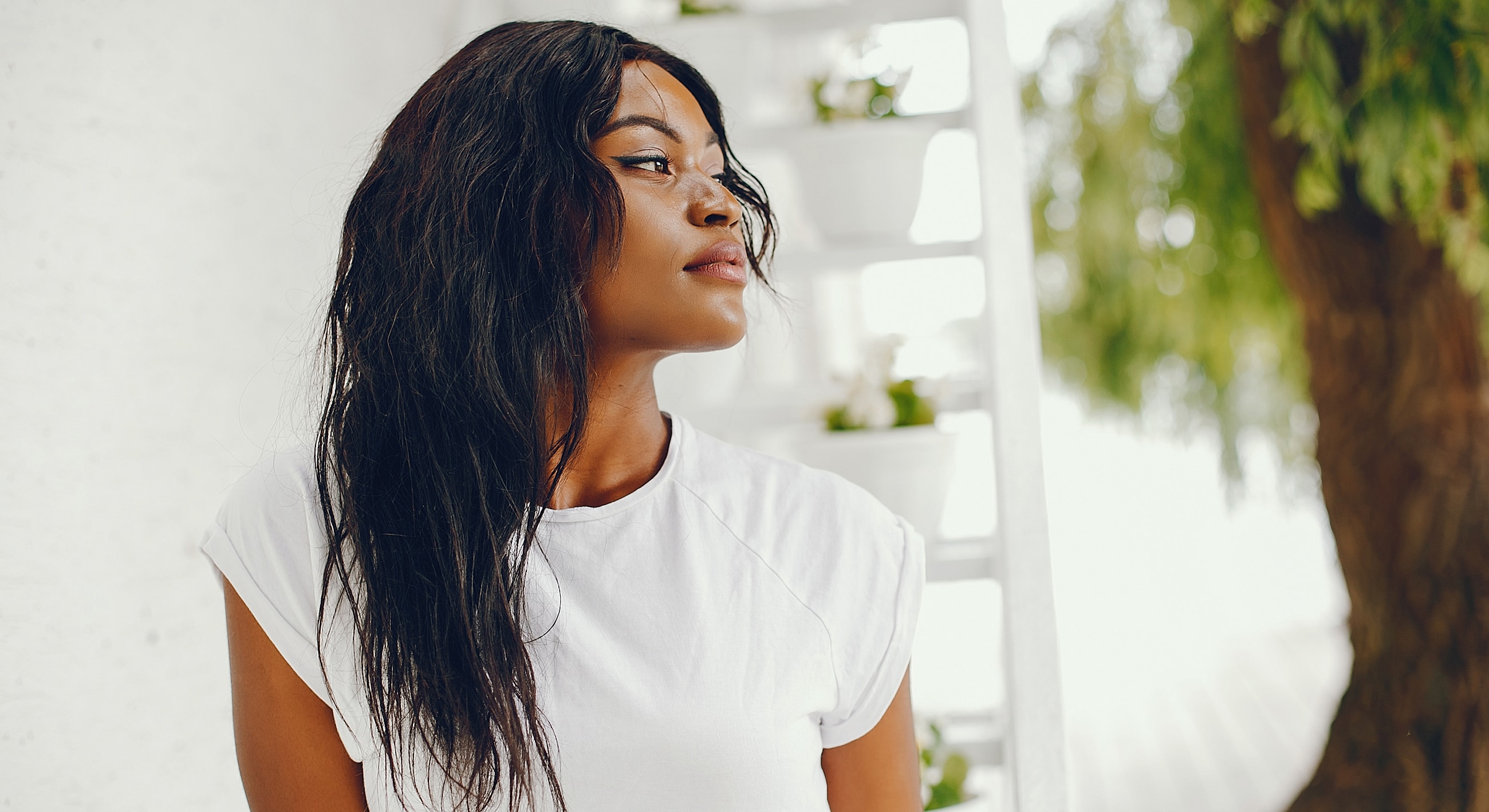 Woman with long hair in natural setting.